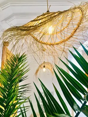 a chandelier hanging from a ceiling with plants at Riad Olika in Marrakech