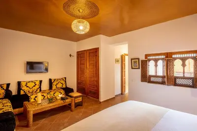 a living room with a bed and a couch at Riad les remparts de la kasbah in Marrakech