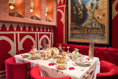 a red dining room with a table with food on it at Riad Hikaya in Marrakech