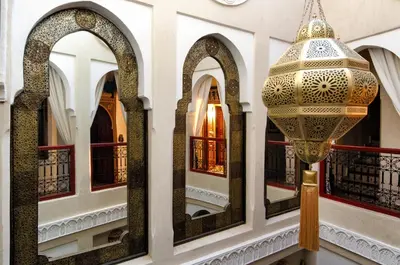 a chandelier hanging from a building with mirrors at Riad Hikaya in Marrakech