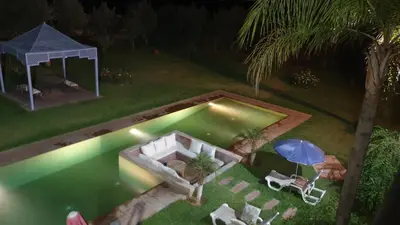 an overhead view of a swimming pool at night at Villa Maloulou in Marrakech