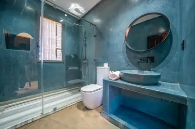 a blue bathroom with a sink and a mirror at Villa Maloulou in Marrakech