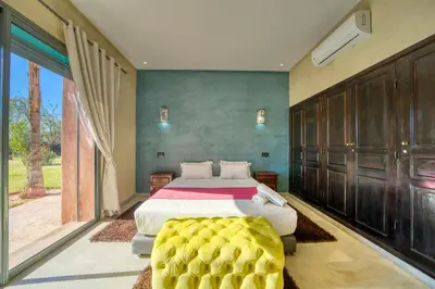 a bedroom with a bed and a large window at Villa Maloulou in Marrakech