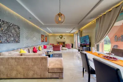 a living room with a couch and a table at Villa Maloulou in Marrakech