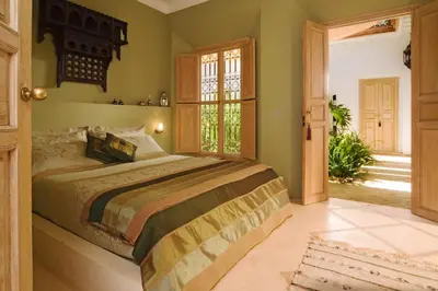 a bedroom with a bed and a large window at Villa Dinari in Douar Caïd Layadi