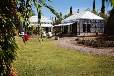 a greenhouse in the middle of a garden at Villa Dinari in Douar Caïd Layadi