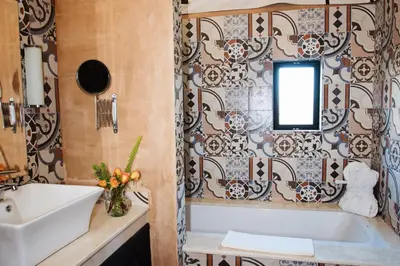 a bathroom with a tub and a sink at Villa Dinari in Douar Caïd Layadi