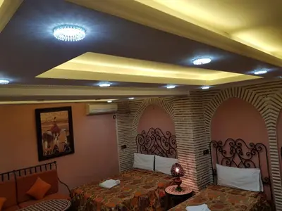 a bedroom with two beds in a room with at Hotel Salsabil in Marrakech