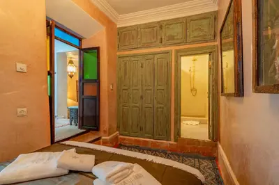 a bedroom with a bed and a large mirror at Riad Yamina52 in Marrakech