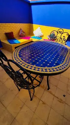 a blue and white table and a chair in a room at Riad Prestigia in Marrakech