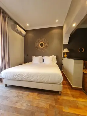 a bedroom with a large white bed in a room at Villa Lila in Marrakech
