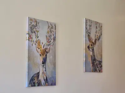 two paintings of a deer on a wall at Appartement chic avec jardin a Prestigia Golf City in Marrakech