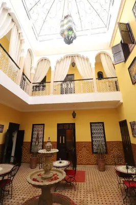a room with tables and chairs and a ceiling at New Bahia in Marrakech