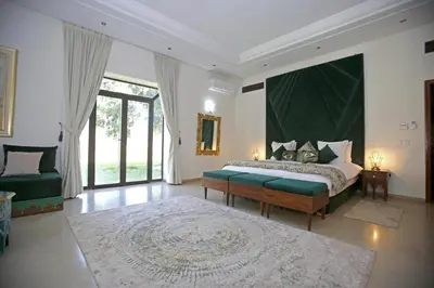 a bedroom with a bed and a large window at Domaine DAR JMEL & Dar Abi Samama in Marrakech