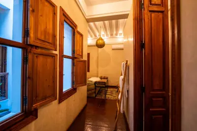 a hallway with wooden cabinets and a window at Riad Les Yeux Bleus in Marrakech