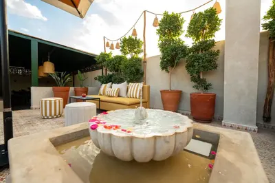 a fountain in the middle of a patio at Riad Les Yeux Bleus in Marrakech