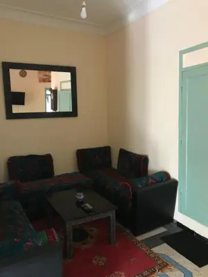 a living room with a couch and a table and a mirror at Dar el Koutoubia in Marrakech