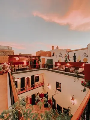 a view from the balcony of a building with a lot of plants at Riad Nanou - Private Riad with Pool & Rooftop in Marrakech