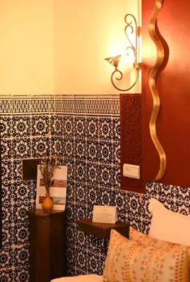 a room with a couch and a table in a room at Riad Nouceiba Marrakech in Marrakech
