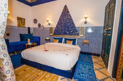a bedroom with a bed and a christmas tree on the wall at Riad Nouceiba Marrakech in Marrakech