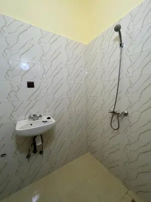 a white bathroom with a sink and a shower at Hotel Zagora in Marrakech