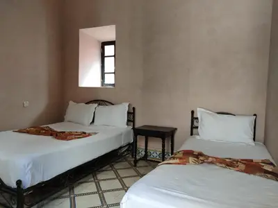 a room with two beds in a room at Hotel Zagora in Marrakech