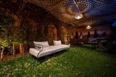 a bed sitting in the middle of a room with grass at Domaine Alma Marrakech in Marrakech