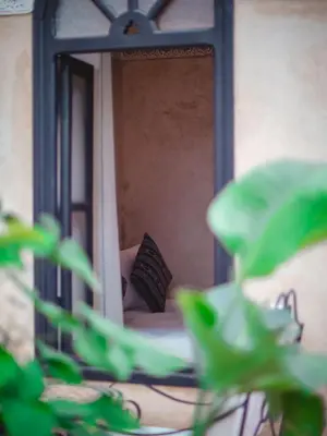 a mirror in front of a bed with a person in it at Riad Amegrad in Marrakech