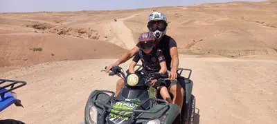 two people on a dirt bike in the desert at Riad Amegrad in Marrakech