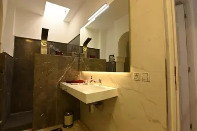 a bathroom with a sink and a mirror at Riad 5 Chambres & Piscine & Breakfast - Marrakech in Marrakech