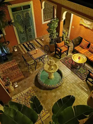 an overhead view of a living room with a table and a fountain at Dar Al Hayat in Marrakech