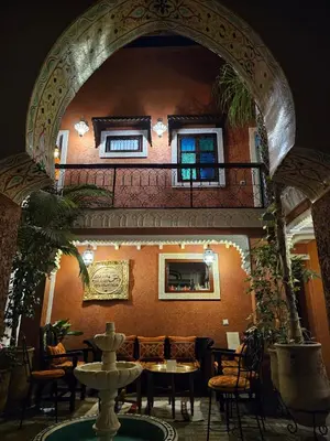 an archway in a restaurant with a fountain in a room at Dar Al Hayat in Marrakech