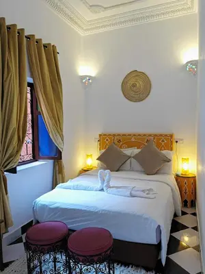 a bedroom with a bed with two towels on it at Dar Al Hayat in Marrakech