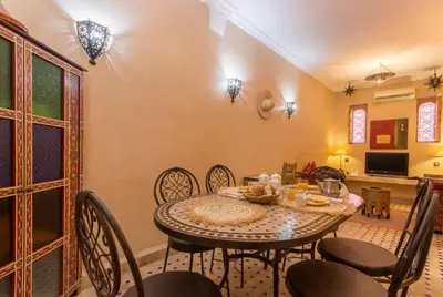 a dining room with a table and chairs at Riad Colette EXCLUSIF - Médina - Breakfast - Wifi in Marrakech