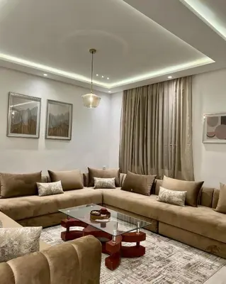 a living room with a couch and a table at Dar Sanaa Marrakech in Marrakech