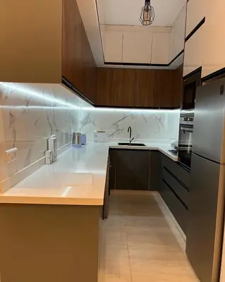 a kitchen with a sink and a refrigerator at Dar Sanaa Marrakech in Marrakech