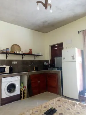 a kitchen with a washer and a white refrigerator at MAISON de VACANCES in Marrakech