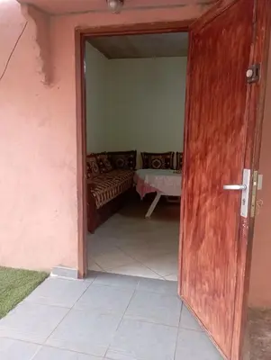 an open door to a room with a couch at MAISON de VACANCES in Marrakech