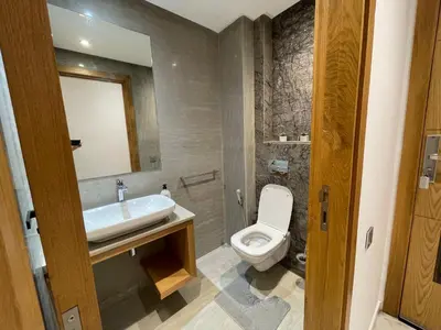 a bathroom with a white toilet and a sink at NEW SUPER LUXURY APARTMENT (CENTRAL MARRAKECH) in Marrakech