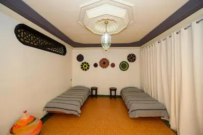a room with curtains and a chandelier at Targafit Hotel & Hammam in Marrakech