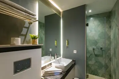 a bathroom with a sink and a shower at AppartHotel Atrani in Marrakech