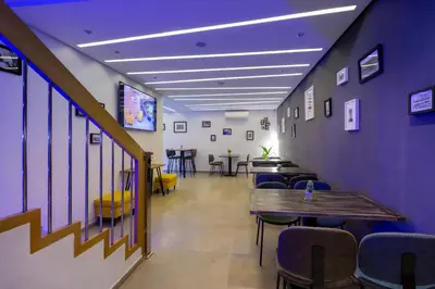 a hallway with a table and chairs in a room at AppartHotel Atrani in Marrakech