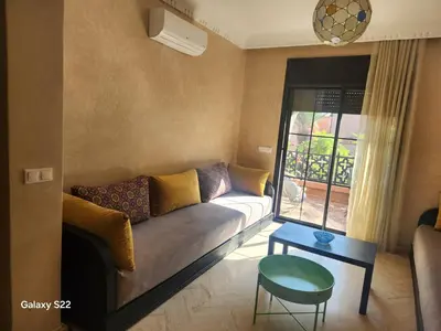a living room with a couch and a table at Atlas golf in Marrakech
