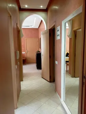 an empty hallway with an archway in a room at Firdaouss apartment in Marrakech