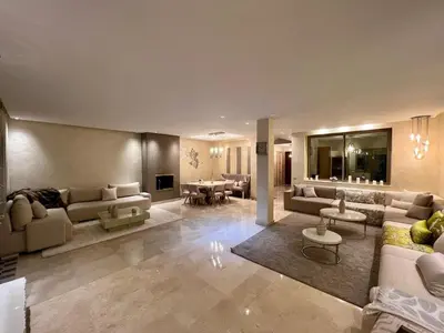 a large living room with couches and a table at Villa golf prestigia marrakech in Marrakech