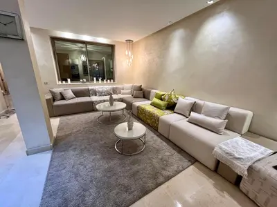 a living room with a couch and two tables at Villa golf prestigia marrakech in Marrakech