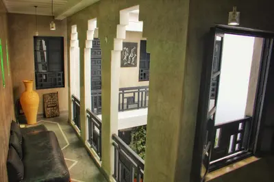 a room with a wall of windows and a couch at Riad Heva in Marrakech