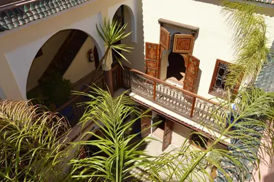 a building with a staircase and some plants at Riad Bonheur in Marrakech