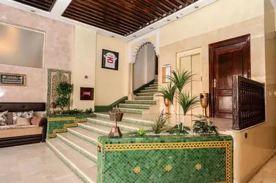 a lobby of a house with stairs with plants at Hotel Majorelle in Marrakech