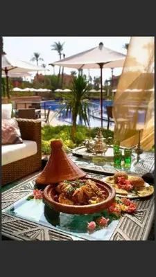 a table with a plate of food on it at Palmeraie Village in Marrakech